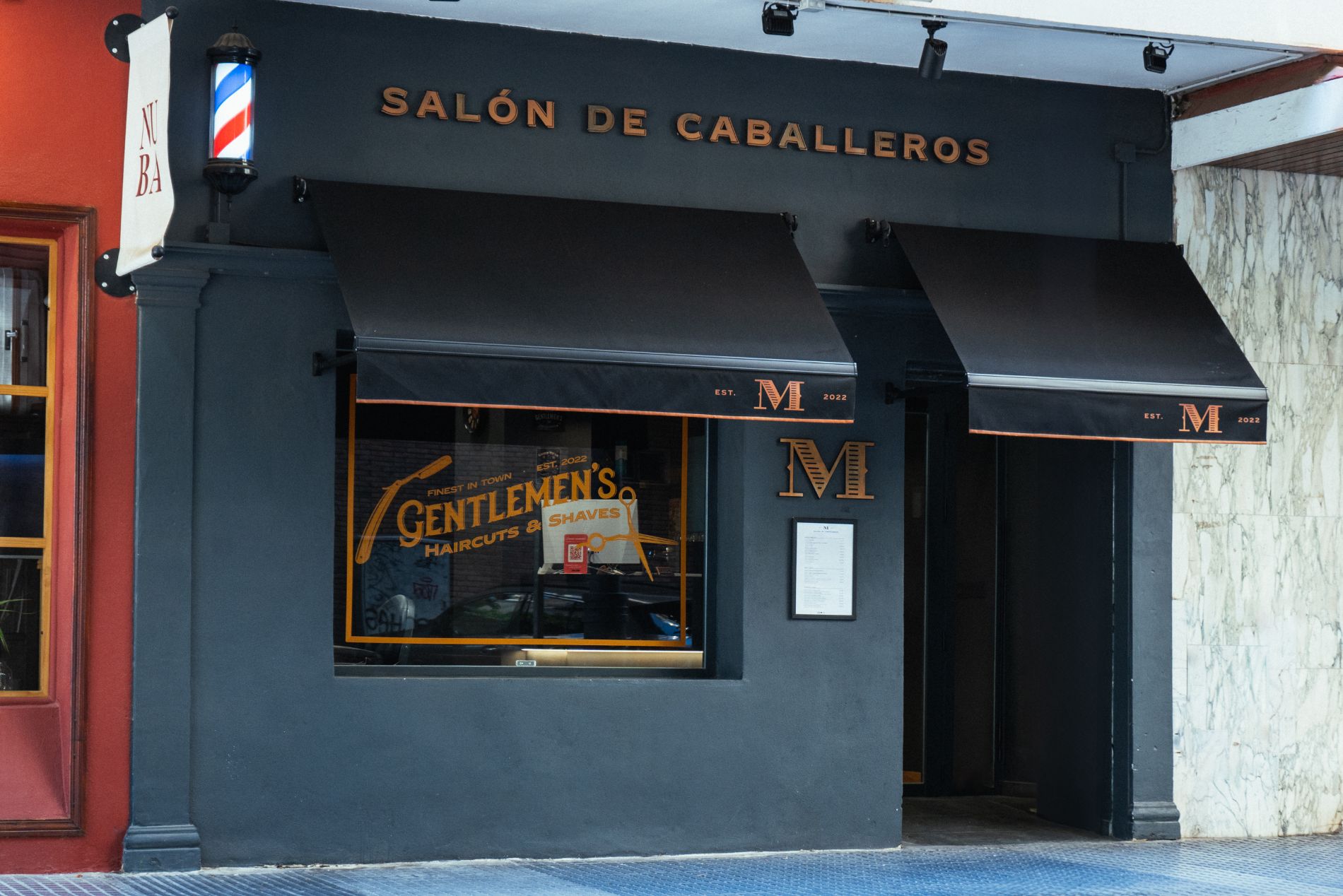 Photograph of the façade of M Salon de Caballeros barbershop on Calle Cervantes 12, Málaga