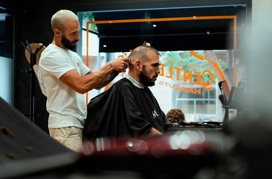 Brian performing a clipper cut service on a client with clippers