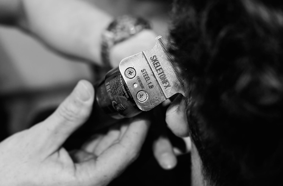 Close-up of clippers during a gentleman's haircut service