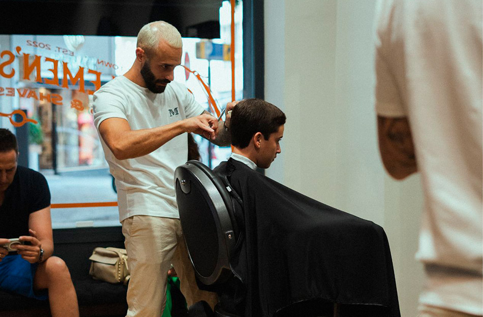 Brian finishing a gentleman's haircut with scissors
