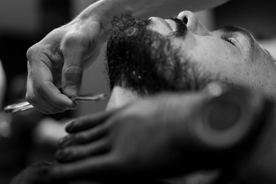 Close-up detail of beard shaving with a straight razor